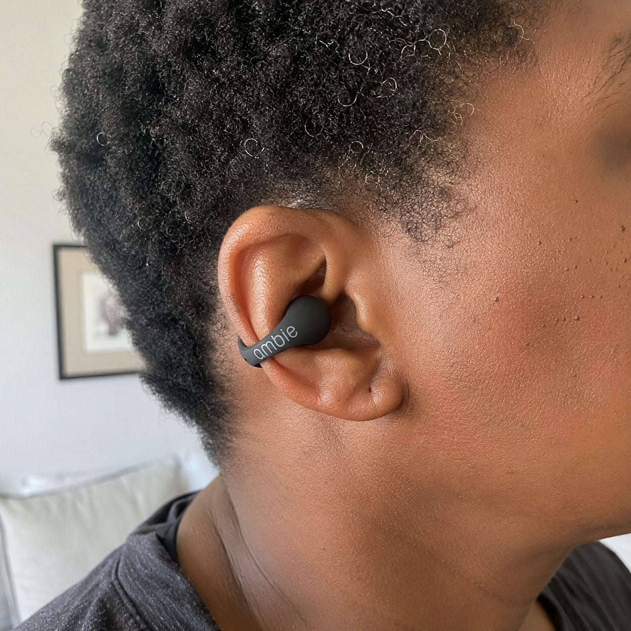 Close-up of the black earcuff clipped on an ear, ear canal open