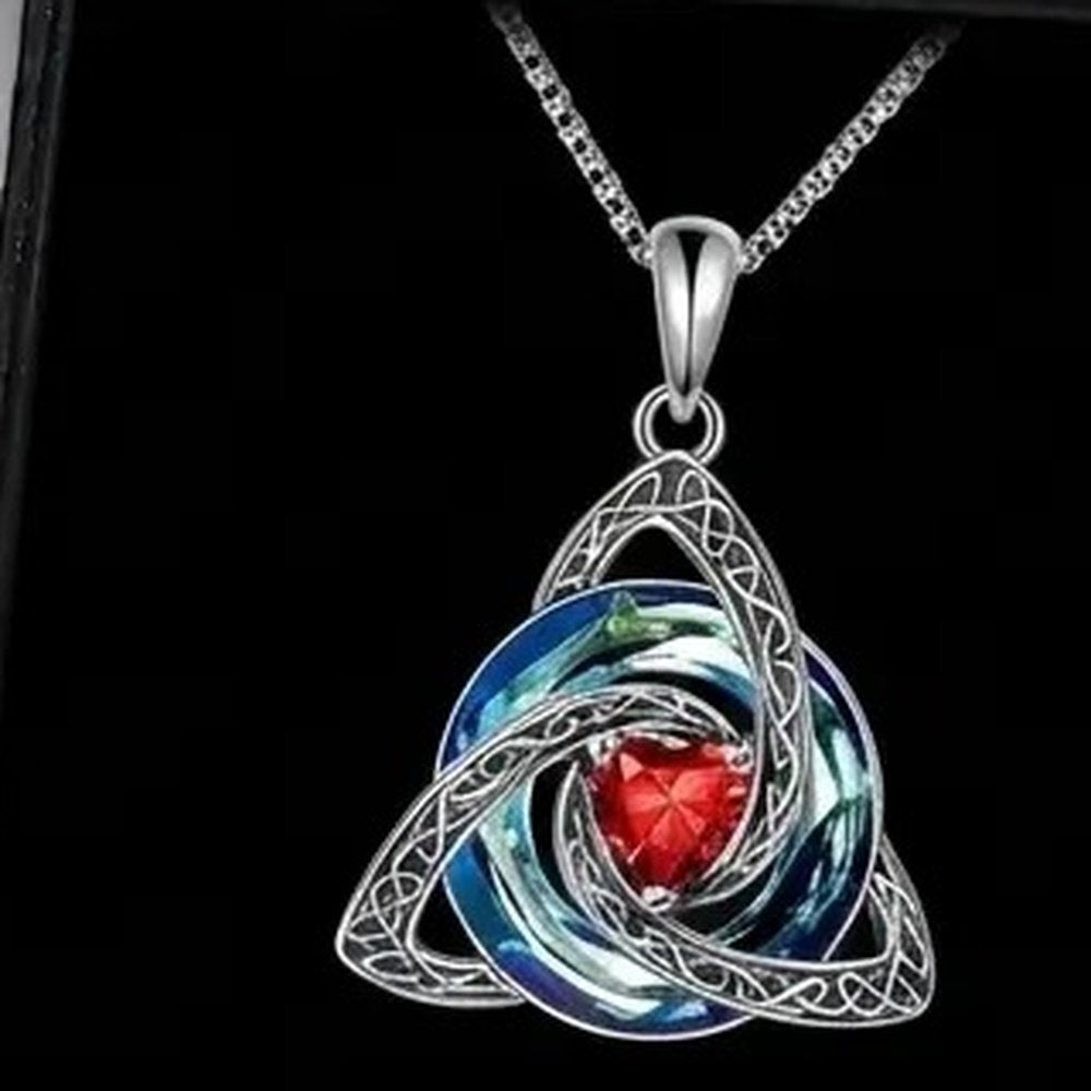 The Celtic knot birthstone necklace shown alone on a dark ground