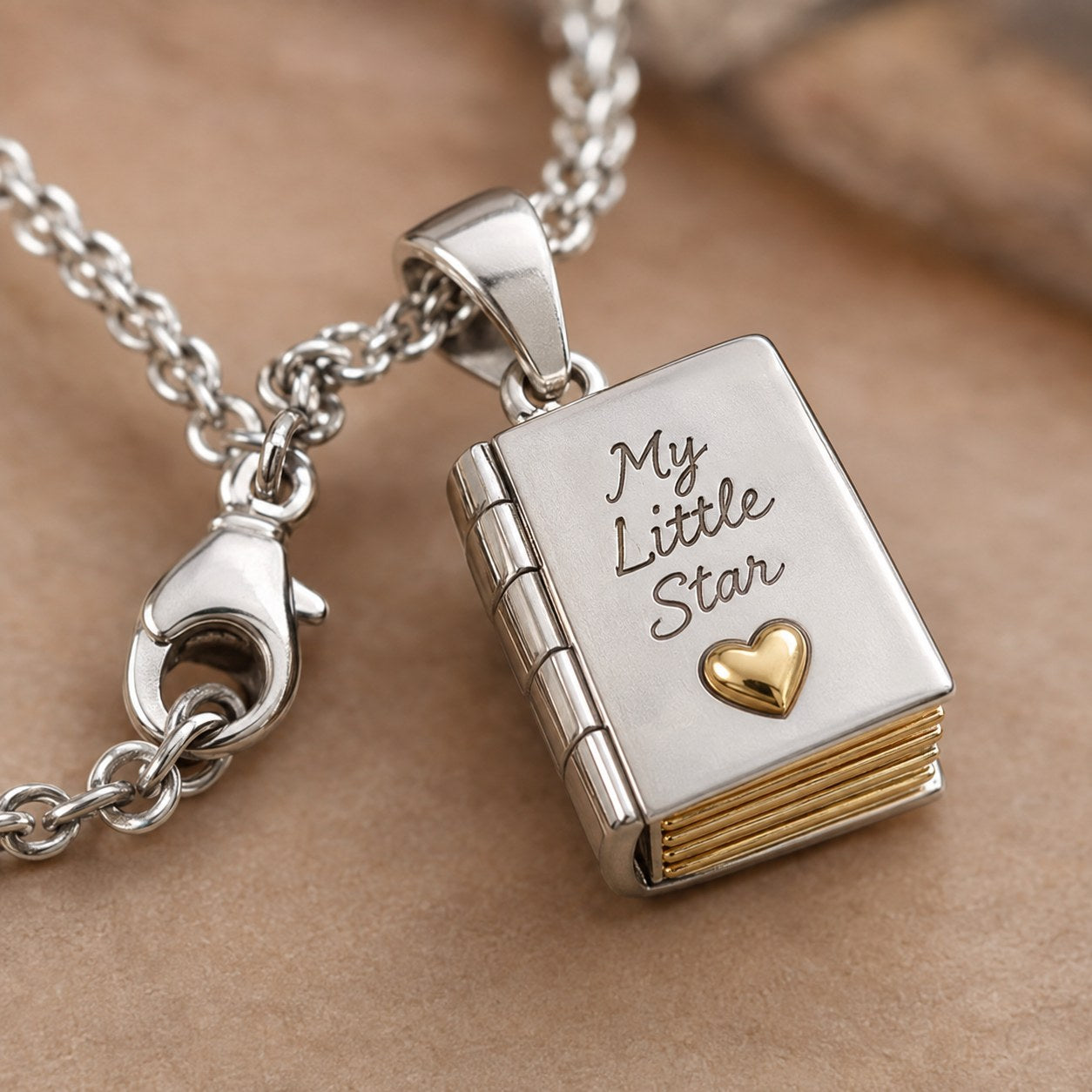 Macro detail of the 18 inch cable chain and secure clasp of the Pomence My Little Star Book Locket Necklace