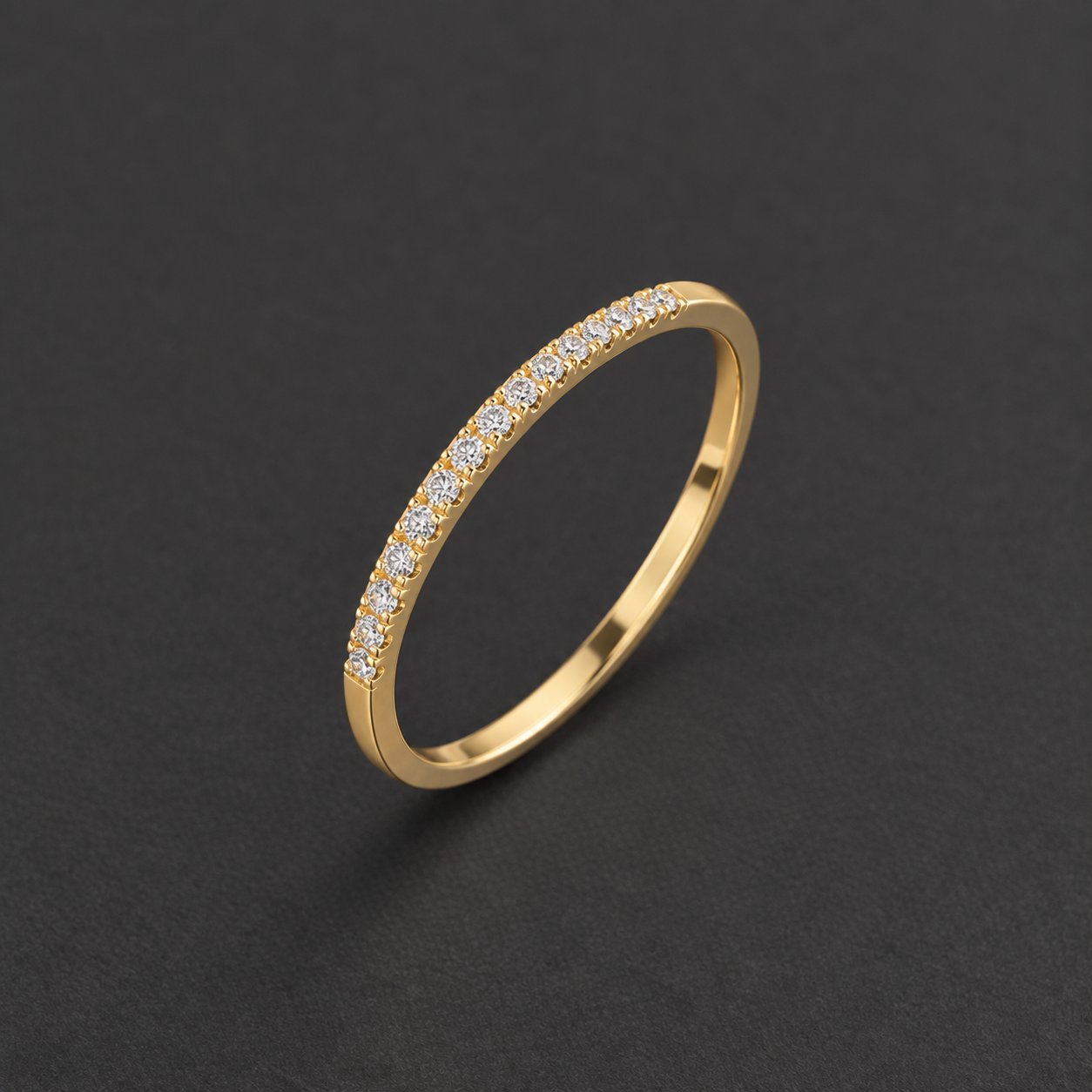 A single Pomence Birthstone Stacking Ring band shown alone on a dark ground