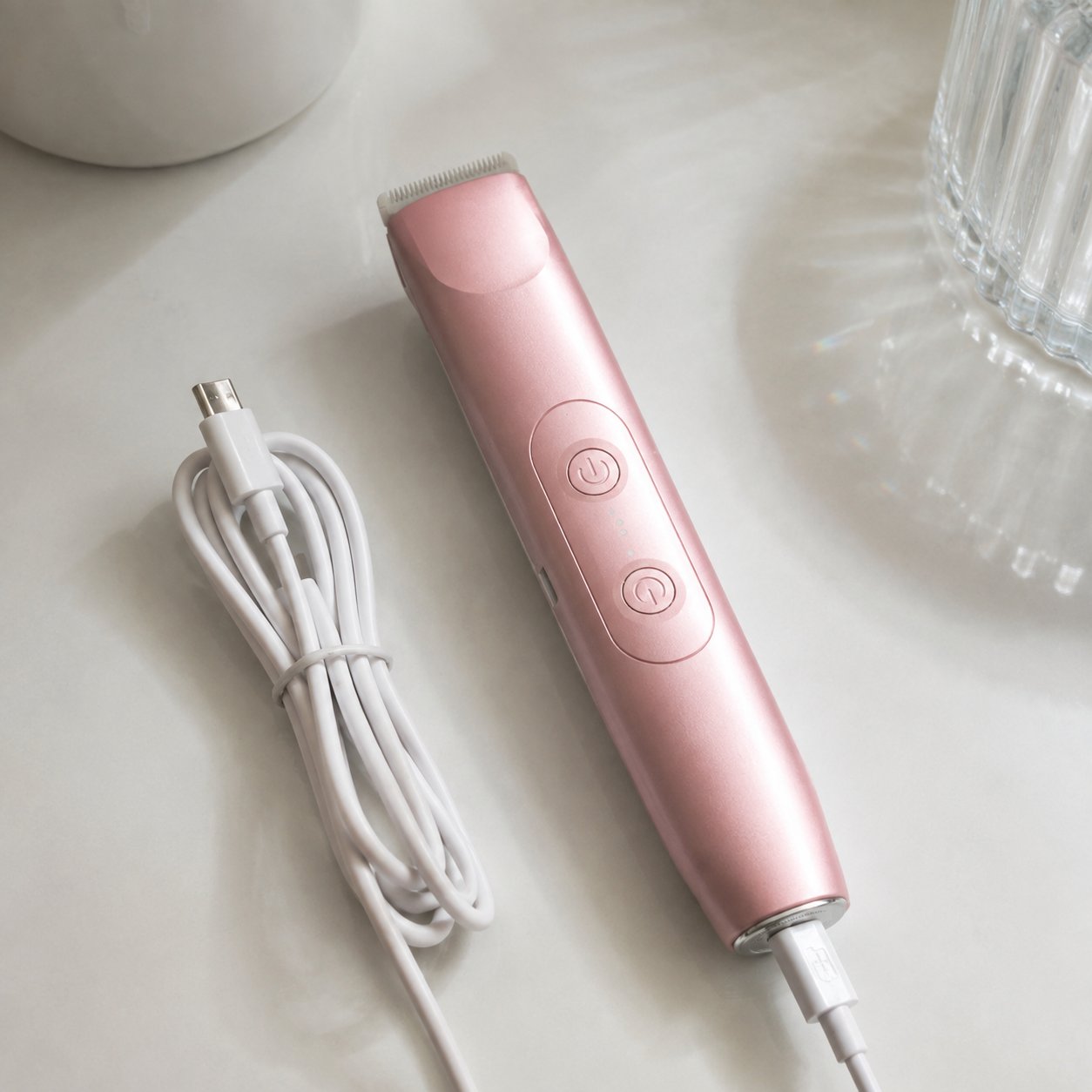 The Pomence 2-in-1 Bikini Trimmer laid flat with its USB-C charging cable