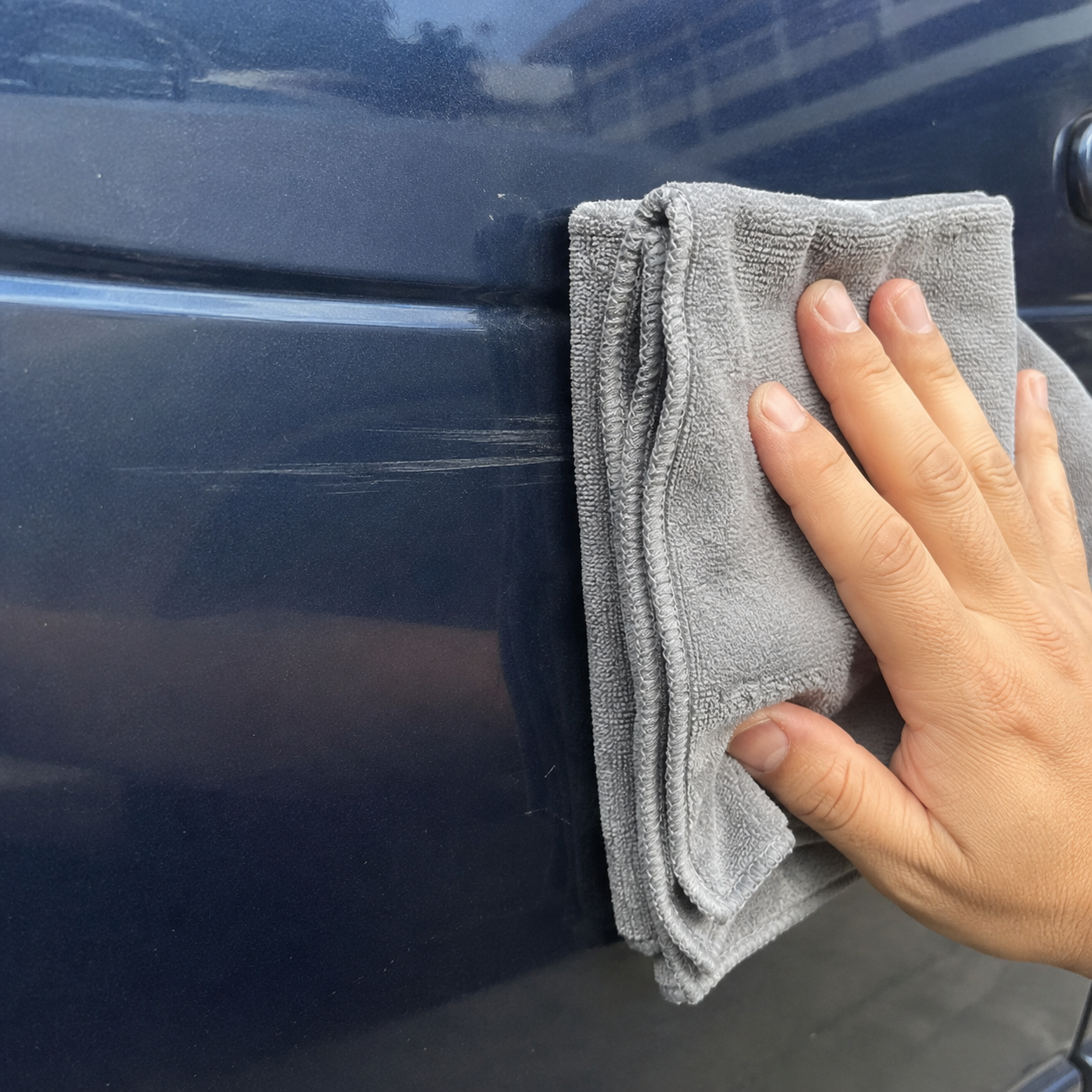 Car Cloth working on a scratched blue car door