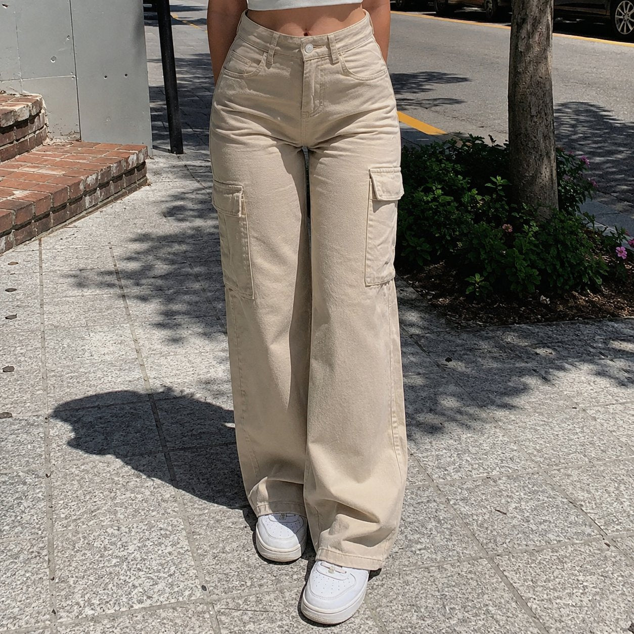 Full-length view of the straight wide leg over white sneakers