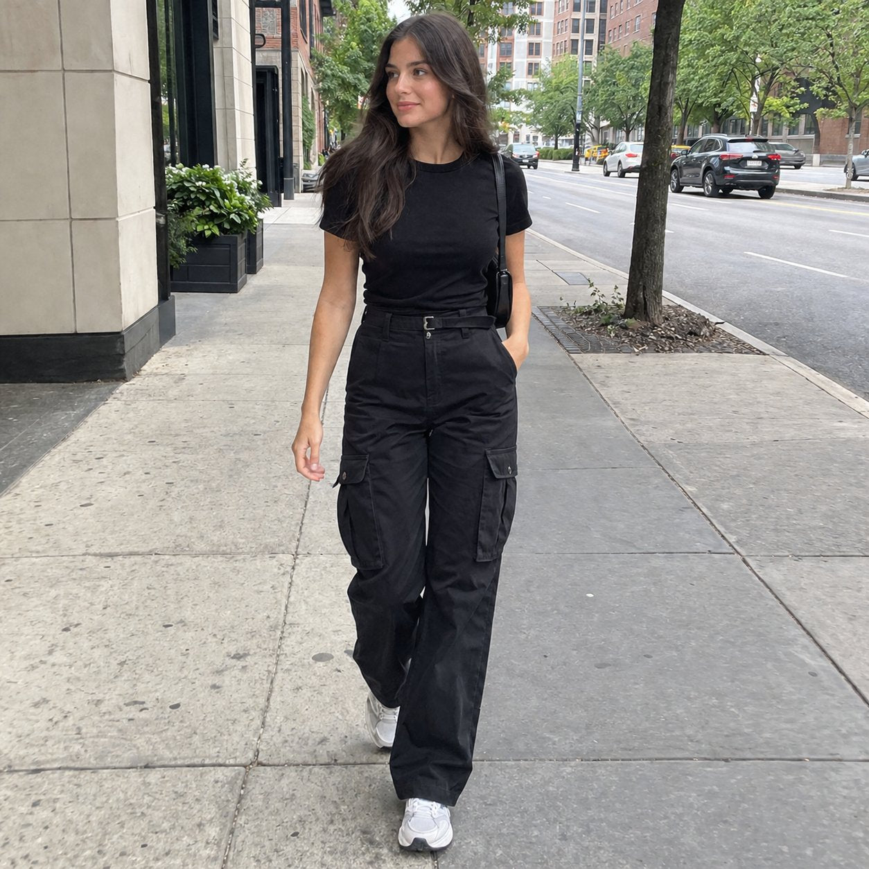 Woman walking on a city street in black cargo pants