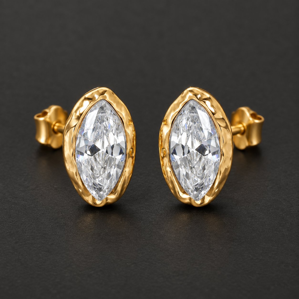 The pair of Pomence Crystal Mini Stud Earrings alone on a dark ground