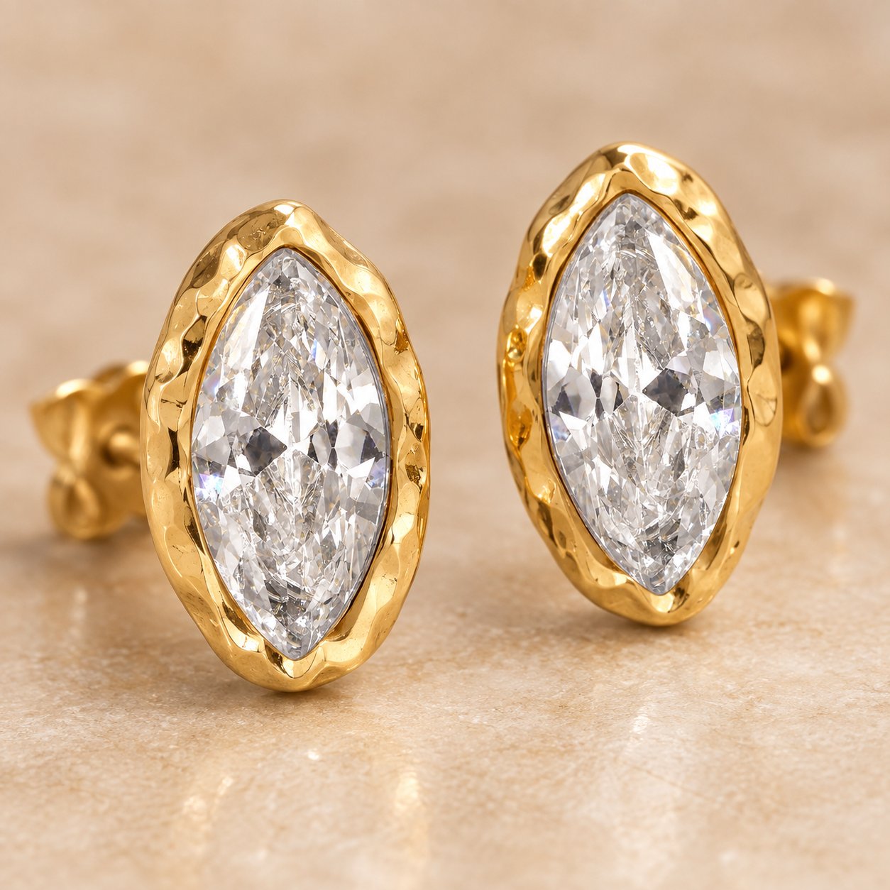 Macro detail of the hammered gold bezel around the marquise crystal on the Pomence Crystal Mini Stud Earrings