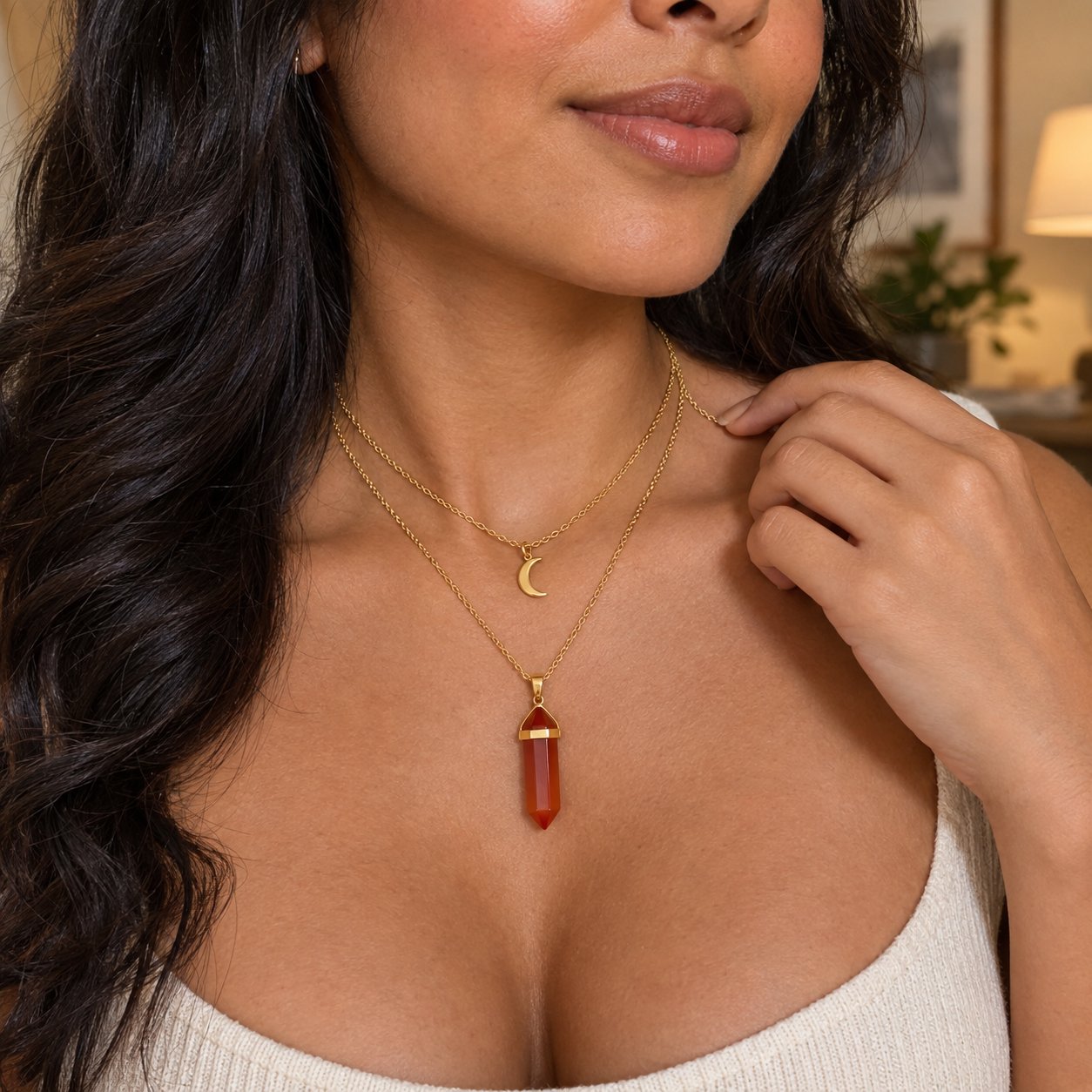 Close-up of the double layered Pomence Carnelian Attraction Necklace, the crescent moon charm on the shorter chain above the carnelian point