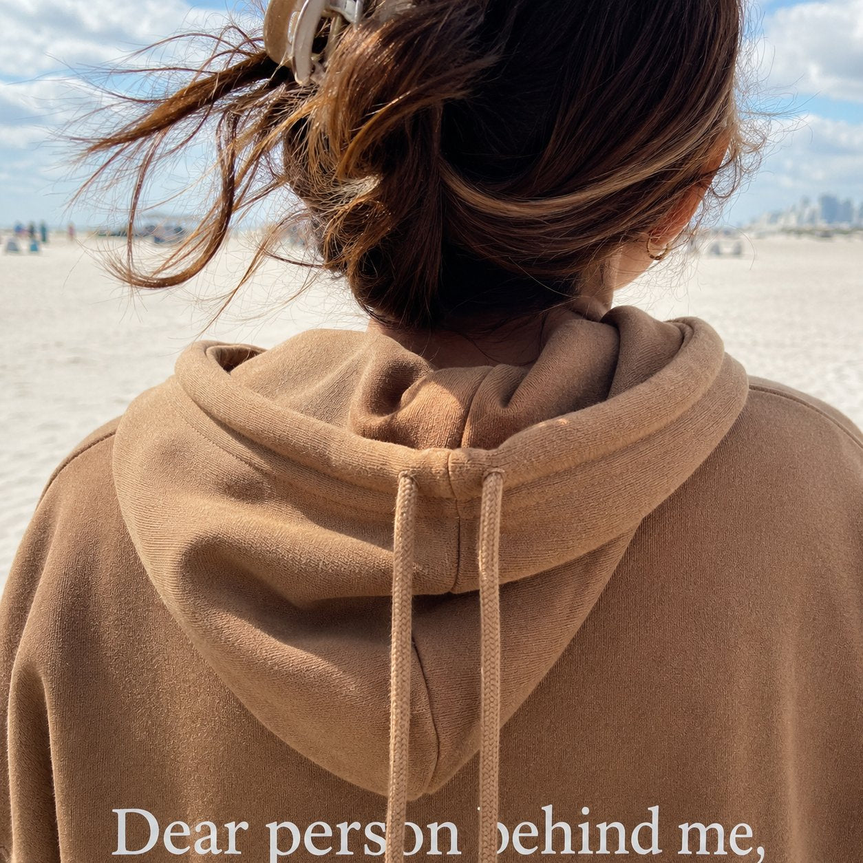 Close-up of the hood and drawstrings of the khaki sweatshirt