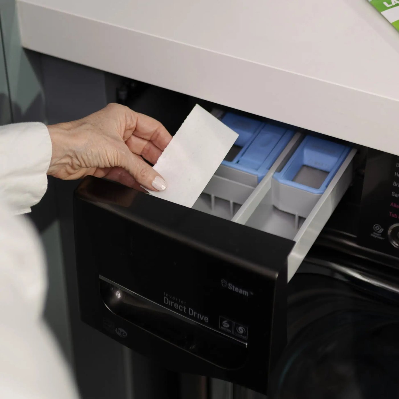 Placing a Pomence Laundry Detergent Sheet into a washing machine's detergent drawer