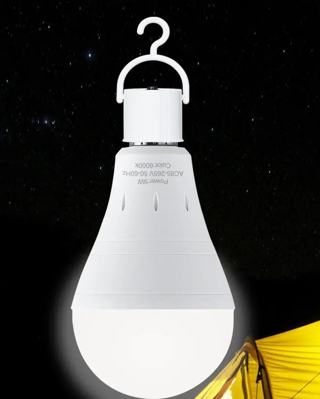 The rechargeable bulb hanging by its hook cover over a tent at night