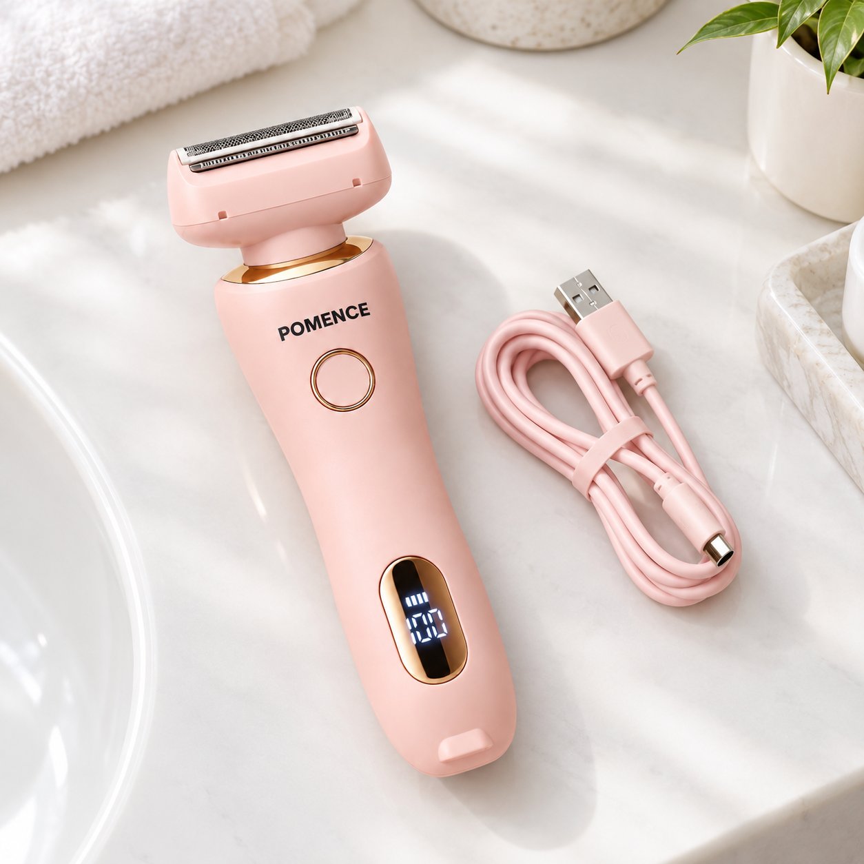 The Pomence Painless Hair Removal Shaver lying beside its USB charging cable