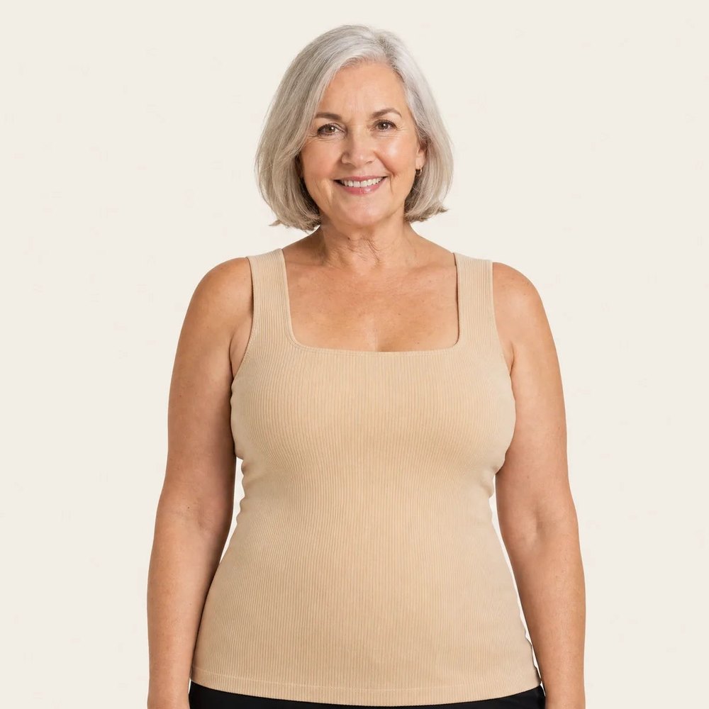 A smiling woman wearing the Pomence Front-Support Bra Tank in Beige, front view