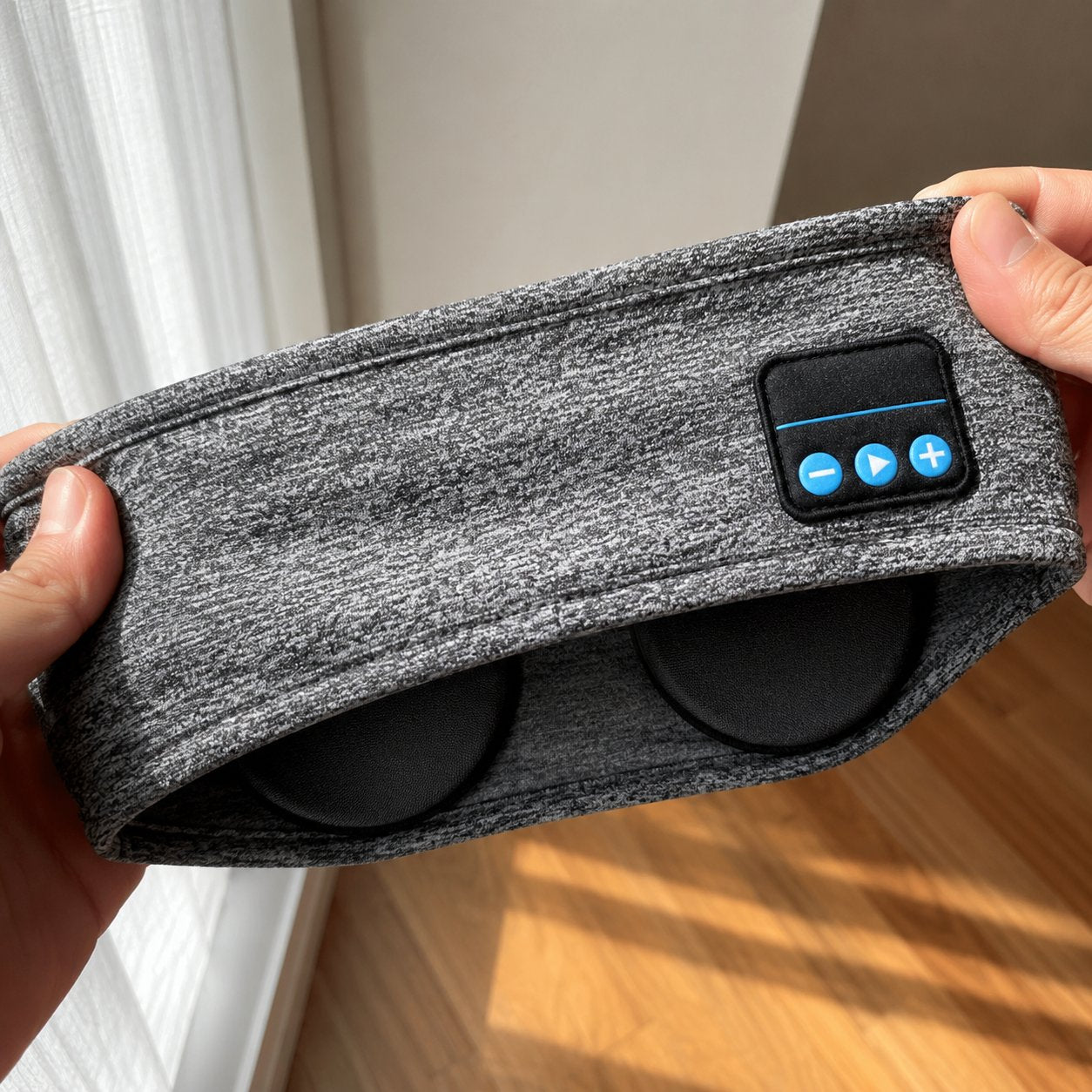 The soft stretch fabric of the grey headband with the thin speakers inside