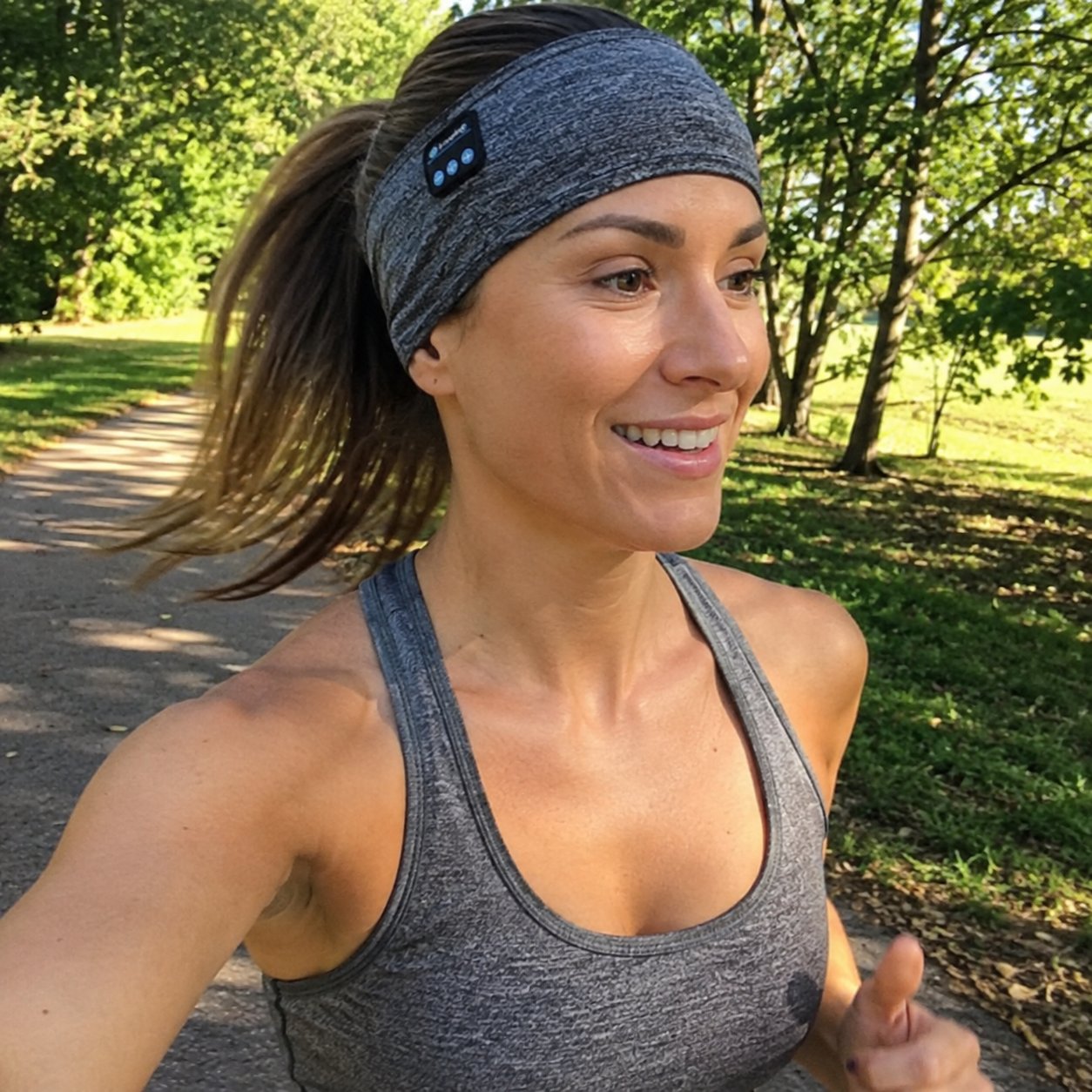 Woman running outdoors wearing the headband