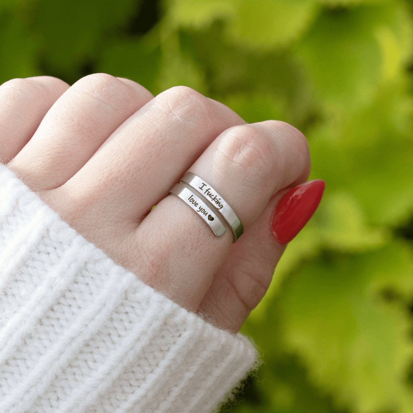 The Pomence I F♡cking Love You Ring worn on an adult hand with both engraved lines readable