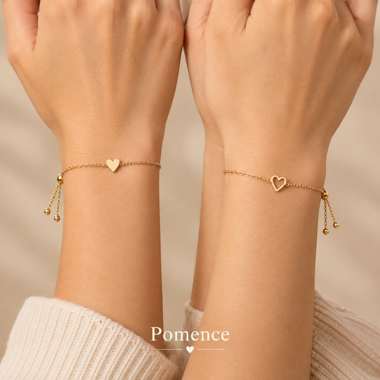 Two gold chain bracelets, one with a solid heart charm and one with an open heart charm