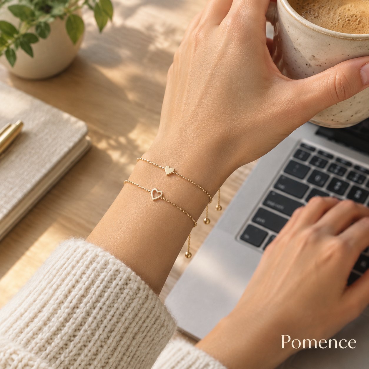 A wrist wearing the heart bracelet with a knit sleeve