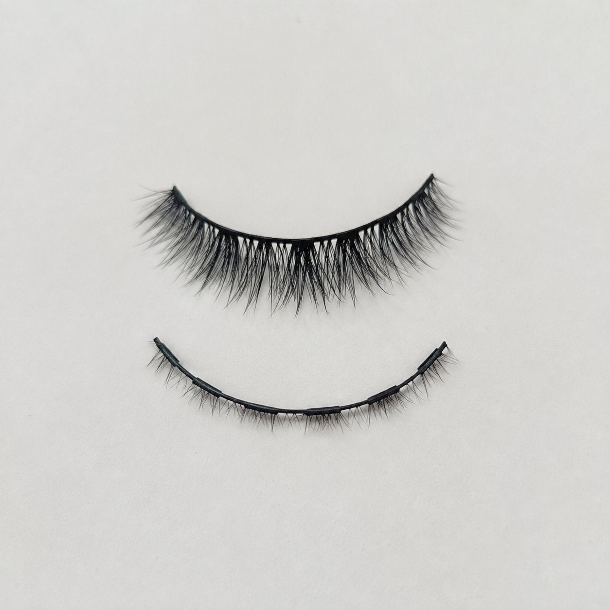 The upper lash piece and lower magnetic piece separated