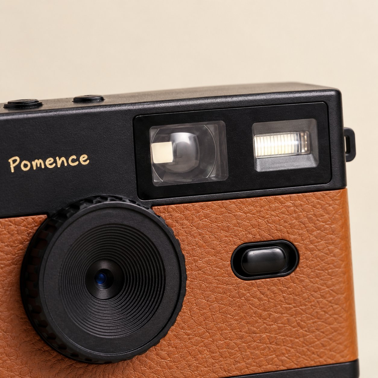 Close-up of the optical viewfinder window and the built-in flash on the Pomence Mini Retro Camera
