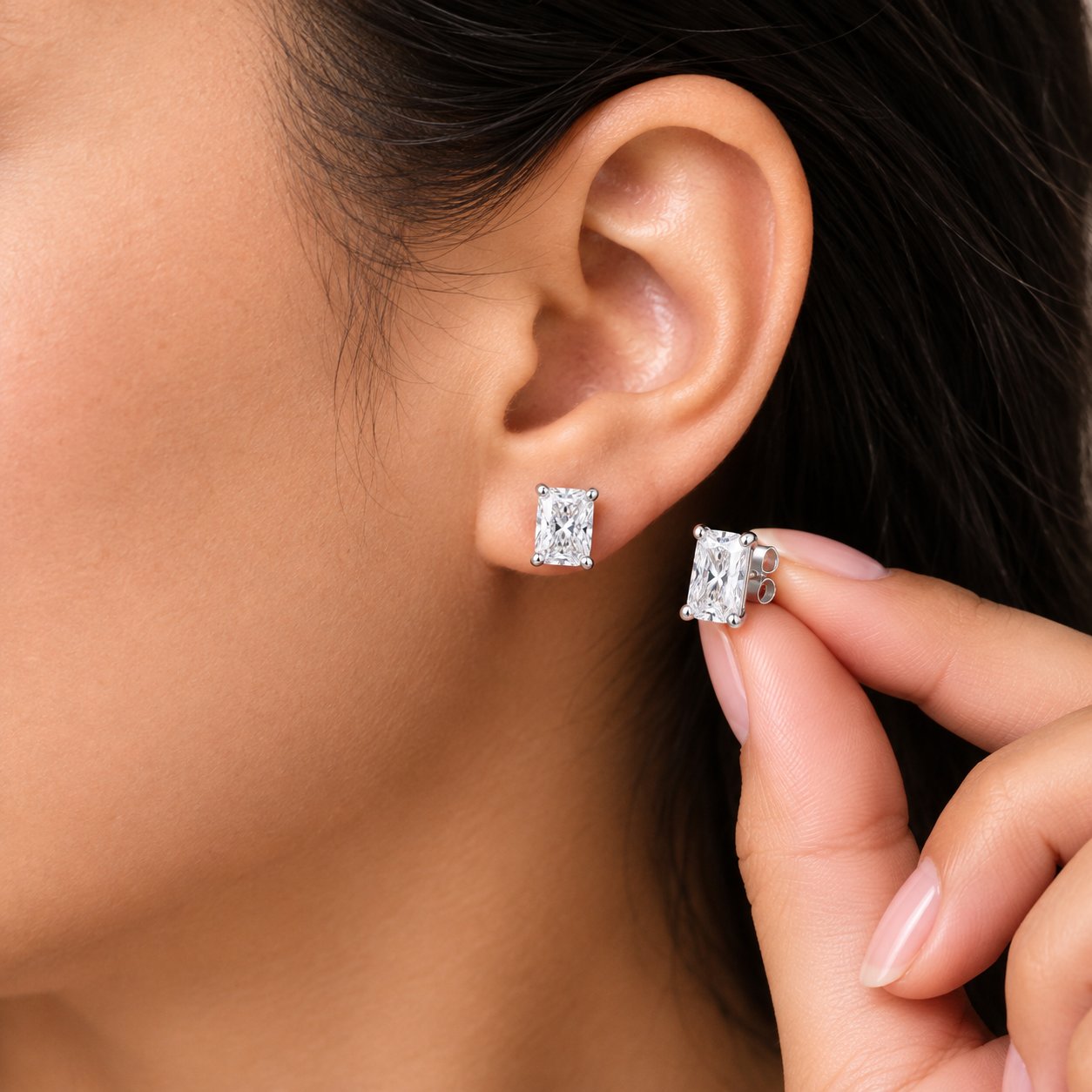 A Pomence Moissanite Stud Earring worn on an adult ear lobe, shown close up in daylight