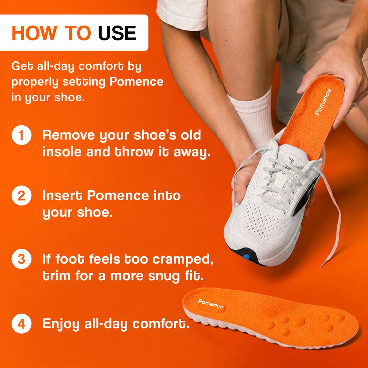 A hand sliding an orange Pomence Massage Insole down into a white trainer after the old flat insole has been pulled out