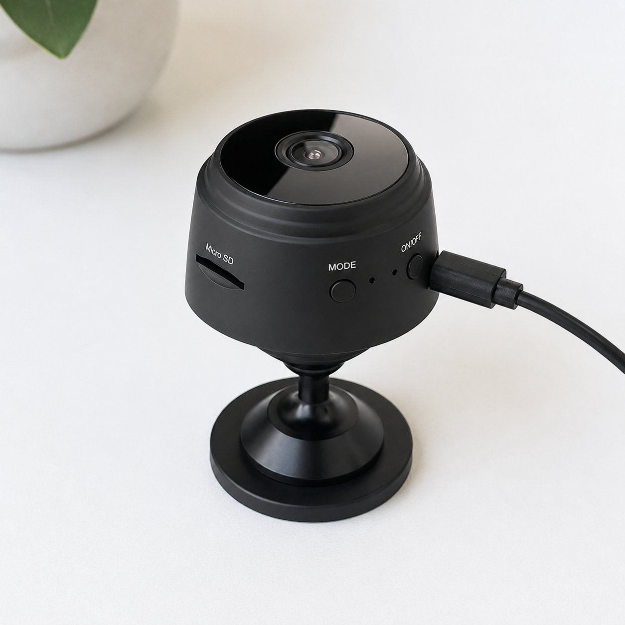 Pomence Mini WiFi Security Camera charging with its USB cable
