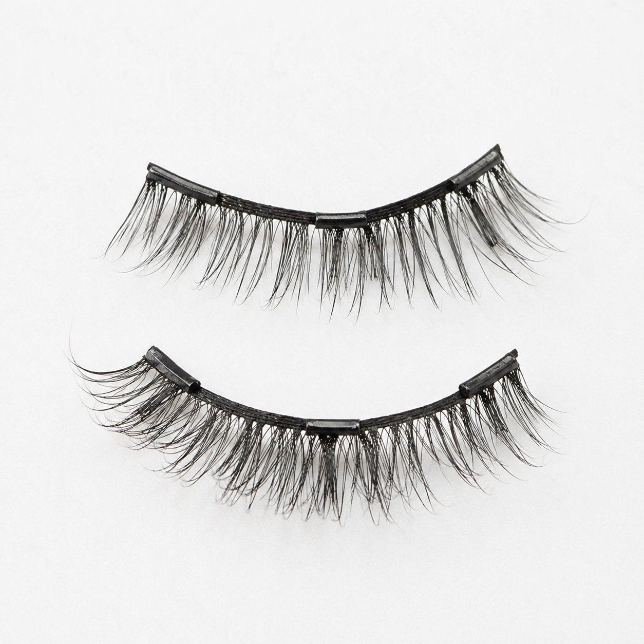 Top and bottom magnetic lash pieces separated, showing how they clip through the natural lash
