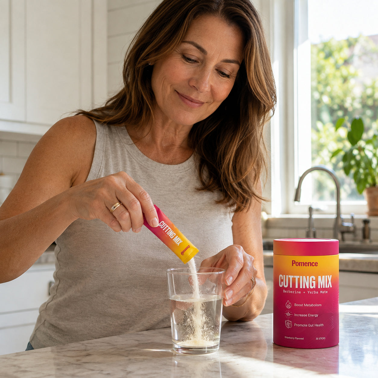 Woman mixing a Pomence Cutting Mix stick into a glass of water