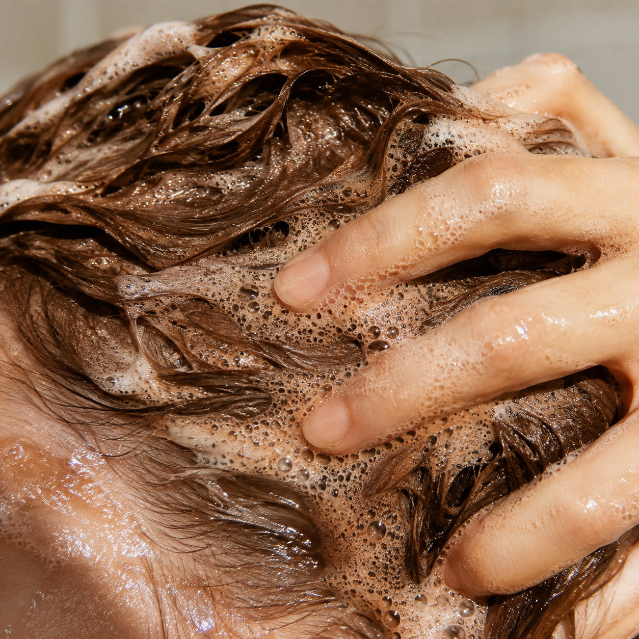Close-up of rich color shampoo lather in the palm of a hand