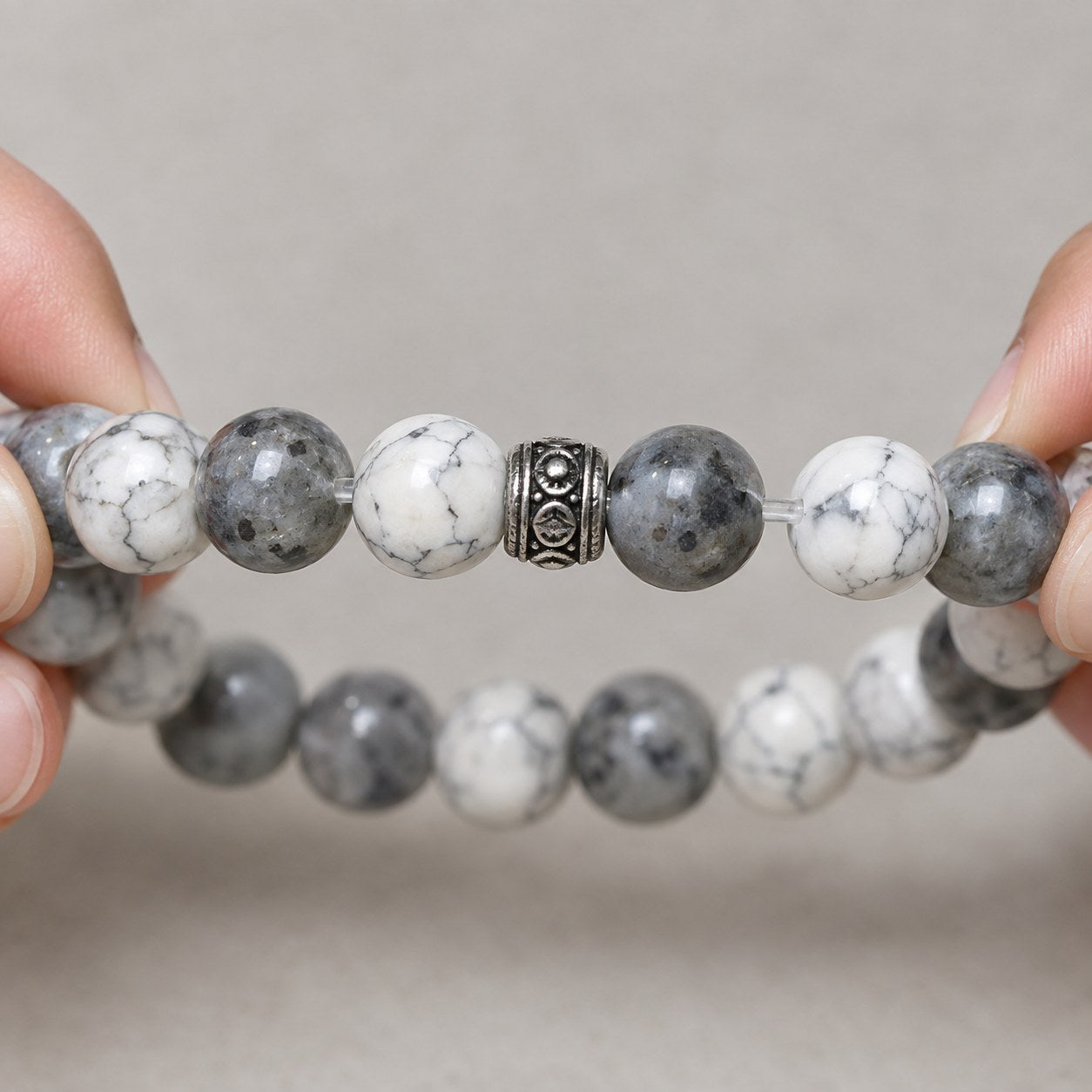 The Pomence Pixiu Wealth Bracelet stretched open to show the elastic cord running through the beads