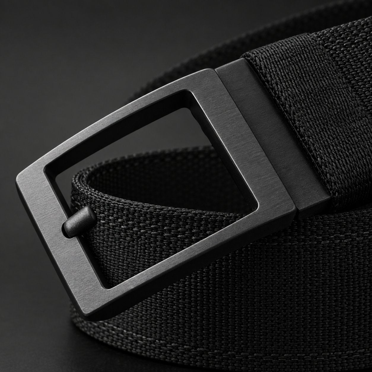 Macro detail of the plain matte black metal ratchet buckle on the Pomence Ratchet Tactical Belt