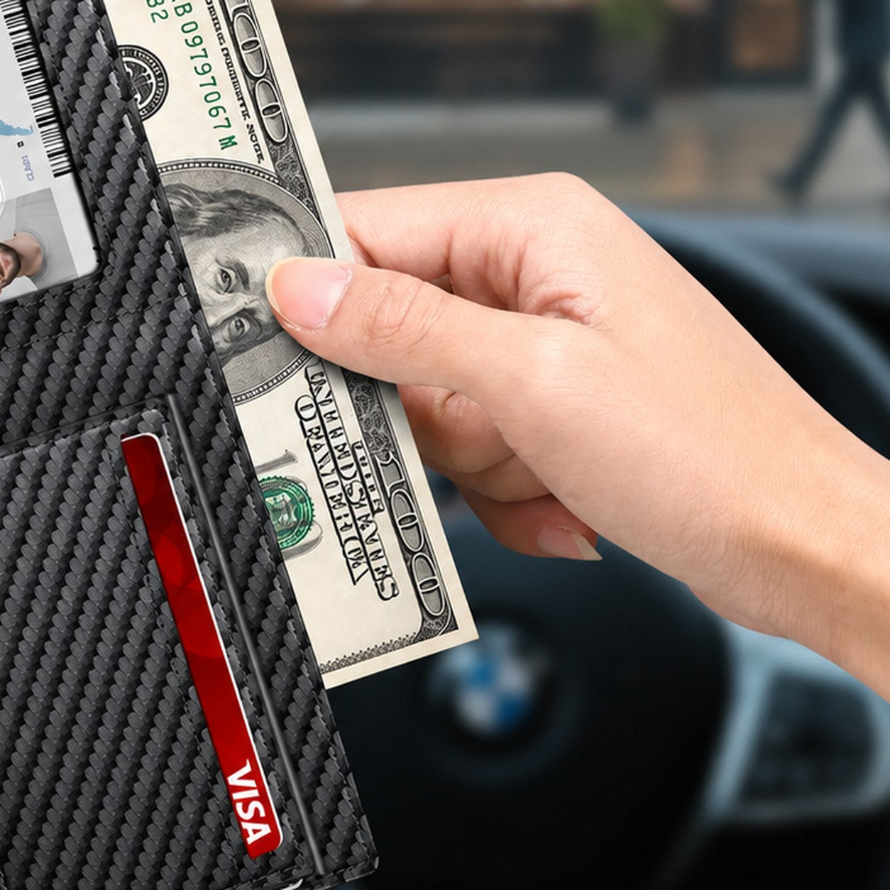 Folded bills held under the money clip of the Pomence RFID Minimalist Bifold Wallet