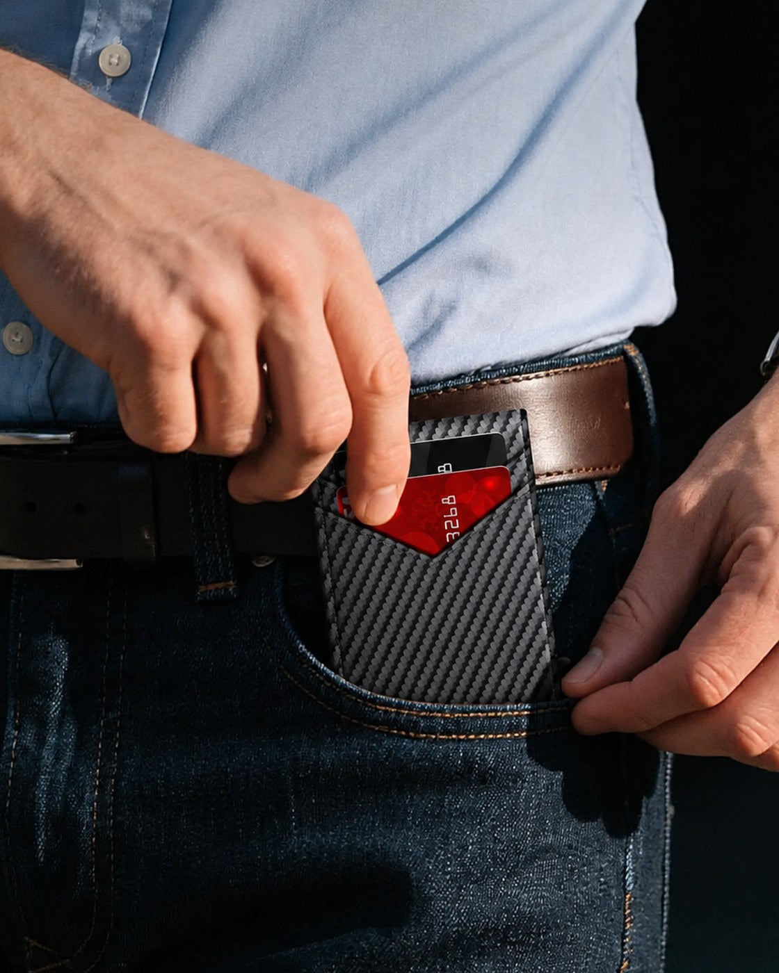 The Pomence RFID Minimalist Bifold Wallet sliding into a front jeans pocket
