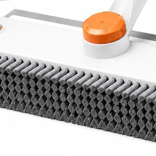 Close view of the stiff gray bristles and the orange center button