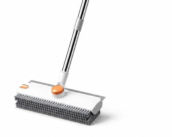 The white and orange Pomence 3-in-1 Floor Scrub Brush head with its stiff gray bristles