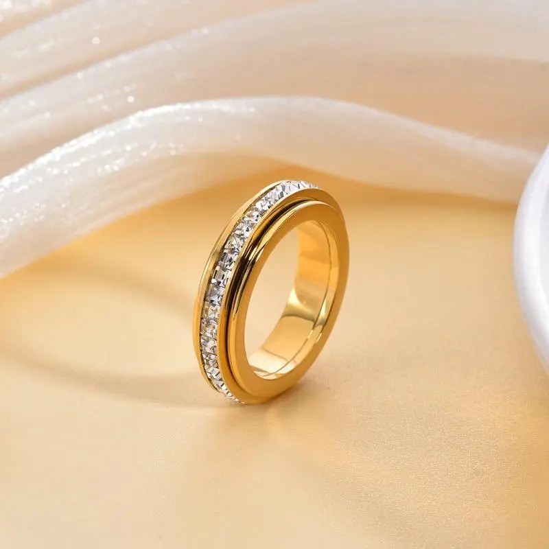 Spinner ring resting on a soft cream surface