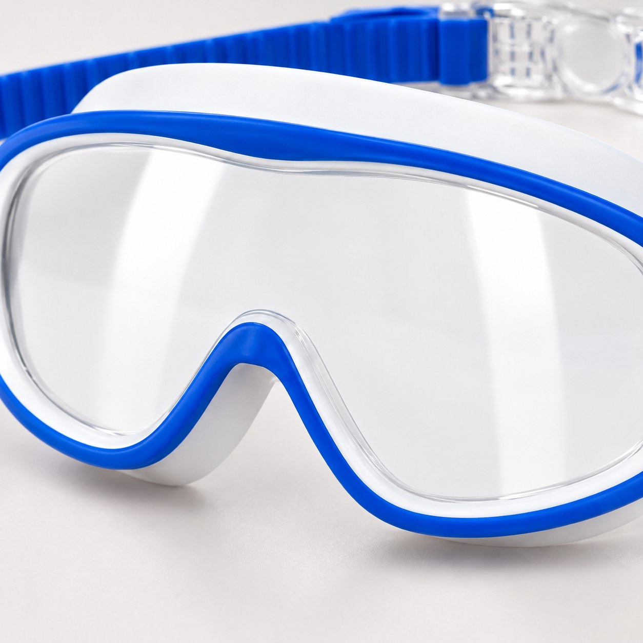 Close-up of the clear snap clasp on the strap of the Pomence Kids Swim Goggles, caught open in a hand