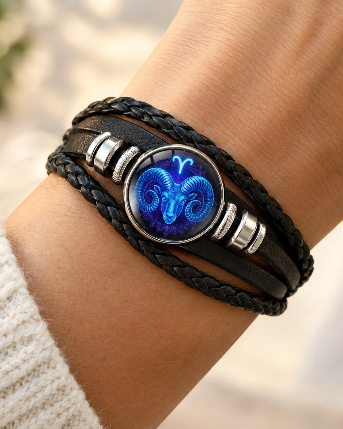 A woman's wrist wearing the Pomence Zodiac Leather Bracelet with the glass zodiac dome facing up